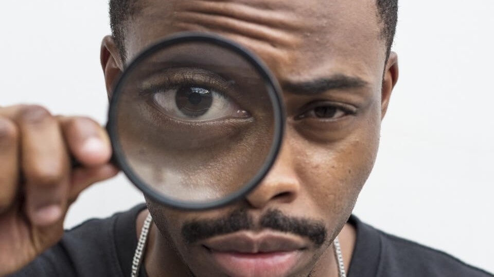 african-man-playing-with-magnifying-glass (1)